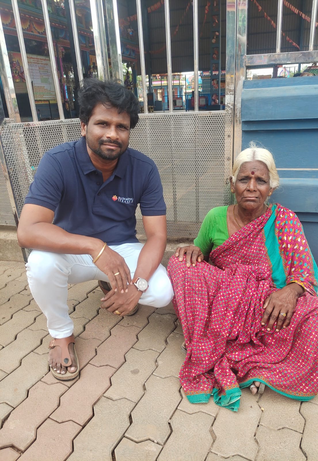 A Blooming Heartz volunteer sitting beside Buchamma at the moment of rescue