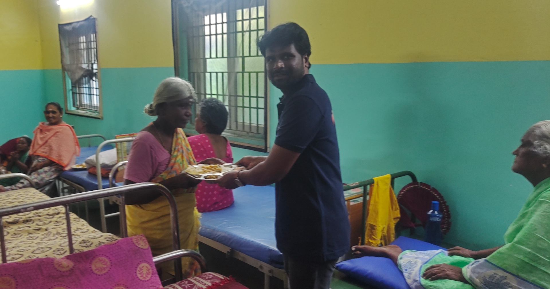 Handing over a meal in the dormitory.