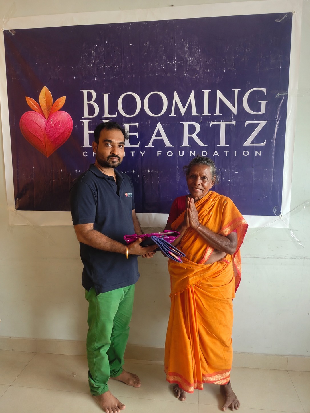 Pattu paati folding her hands in gratitude after receiving new clothes